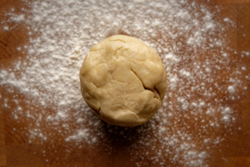 Top view of pie dough rolled into a ball on a floured board