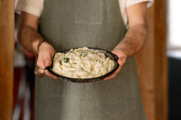 Chef showcasing a delicious mashed potato dish