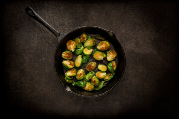 Top view of a pan of brussels sprouts in dim lighting © Wirestock