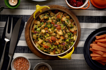 Top view of a dish of turkey stuffing on a Thanksgiving dinner table