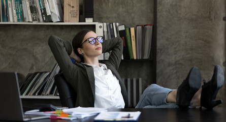 Calm businesswoman relaxing at comfortable office chair hands behind head, happy woman resting in...
