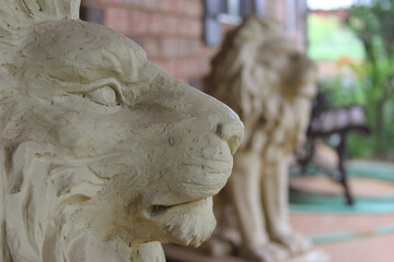 Two lion sculptures guard the building entrance