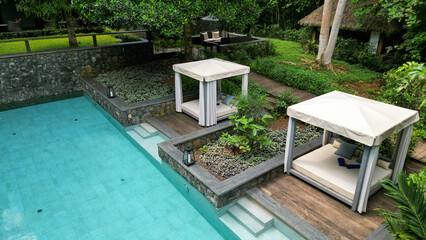 Aerial view from a daybed by the pool at a resort.