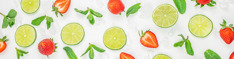 Ice cubes, mint and cut strawberry lime. Fresh fruits background