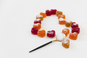 Sweet candied fruit jelly on white background. Heart love concept