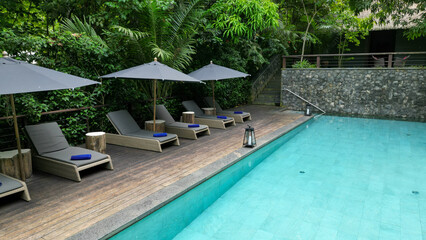 Scenic view of an outdoor garden pool with lounge chairs in Sao Tome, Africa