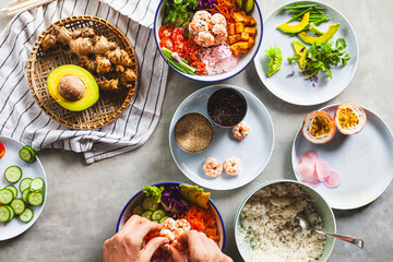 Poke bowl with shrimp prepared by the chef containing white rice, mango, avocado, tomato, etc.