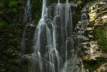 Scenic view of a waterfall cascading over rocky cliff