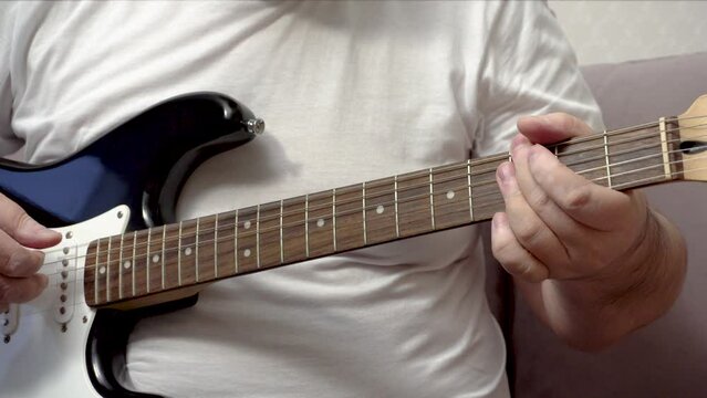 Playing guitar chords. Jazz accompaniment. Close-up. Hands of the performer.