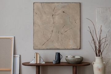 Minimalist composition of living room interior with mock up poster frame, wooden consola, vase with branch, ceramic bowl, black pitcher, books and personal accessories. Home decor. Template.