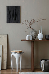 Creative composition of living room interior with mock up poster frame, wooden consola, vase with branch, sculpture, white stool, beige wall, carpet and personal accessories. Home decor. Template.