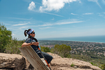 Hiker contemplates the Mediterranean coast from the top of the mountain.