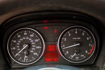 Black speedometers with red small screens and needles