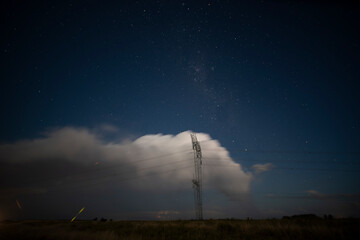 High voltage power line in a nocturnal landscape, La Pampa, Patagonia, Argentina.