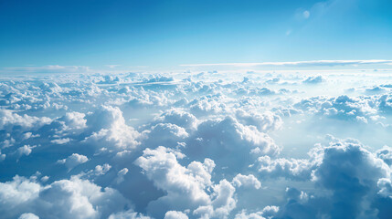 Fototapeta premium Aerial view of fluffy white clouds and blue sky. Download this stunning aerial photograph of a breathtaking cloudscape, featuring fluffy white clouds against a vibrant blue sky.