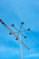 Low angle view a street lamp and construction crane
