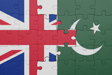 puzzle with the colourful national flag of pakistan and flag of great britain.