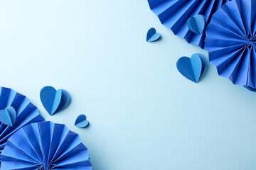 Blue paper hearts and fans on a light blue background. Perfect for Valentine's Day, weddings, or...