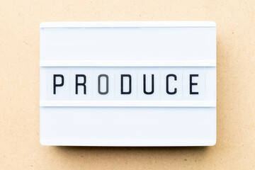 White lightbox with word produce on wood background