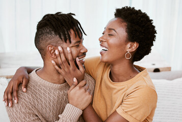 Laughing, black couple and embrace in living room, man and woman with love, romance and relax in...