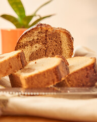 A marbled pudding on a wooden board cut into portions