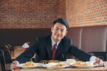 Businessman eat Steak having lunch at a restaurant. Ribs eye steak with mashed potato, salad cream French fries Barbecue Grill and Spaghetti, Happy man sitting have dinner enjoying food