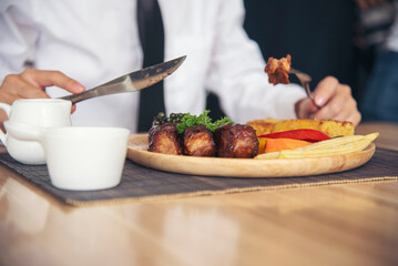 Businessman eat Steak having lunch at a restaurant. Ribs eye steak with mashed potato, salad cream French fries Barbecue Grill and Spaghetti, Happy man sitting have dinner enjoying food