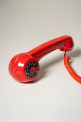 Vintage-styled red telephone handset receiver and bent arm