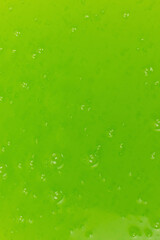 Green slime toy as a background.