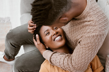 Couple, black woman and smile on lap of man, lounge and relax for romance, break and love in...