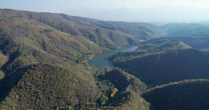 Hidden mountain lake in macedonia between hills, aerial view