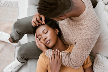 Couple, black woman and sleeping on lap of man, lounge and relax for romance, break and love in...