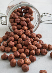 Raw healthy organic hazelnut nuts snack in glass jar on white kitchen table.Macro.