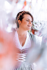 beautiful, young, bavarian woman in traditional costume, dirndl, walks across the oktoberfest with...