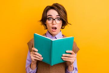 Portrait of speechless impressed woman wear knit waistcoat in glasses read interesting excited book...
