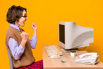 Photo portrait of attractive young woman raise fists celebrate victory dressed retro office clothes...