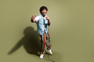 Full body photo of attractive young man sing microphone karaoke have fun dressed stylish denim...