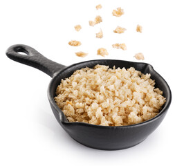 Panko bread crumbs in a sauce pan isolated on white background. Flying bread crumbs. With clipping path.