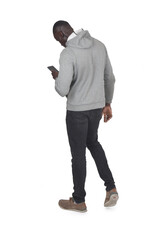 back,side view of a man walking and looking at smartphone on white background