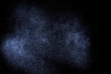 Black and blue grunge texture. Abstract splashes of water on dark background. Light clouds overlay texture on black backdrop.