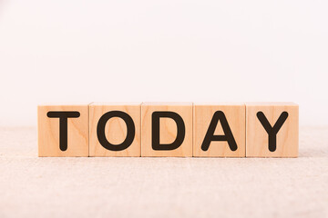 Word TODAY made from wooden cubes on a light background