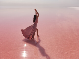 Fashionable Young Woman in Pink Long Dress on Salty Pink Lake 