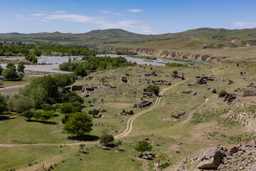 Beautiful landscape view of hills and river in Georgia near Uplistsikhe ancient cave town	
