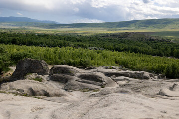 Beautiful landscape view of hills and river in Georgia near Uplistsikhe ancient cave town	
