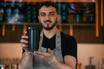 Drink is in hand. Man is serving delicious street food