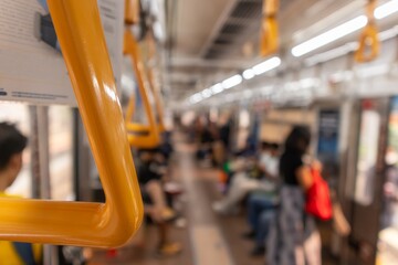 Close-up view of handrail on the commuter train. Hanging handle grip on public transportation with blurred background.