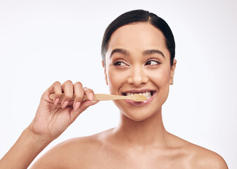 Smile, woman and brushing teeth in studio for dental care, hygiene and fresh breath on white...