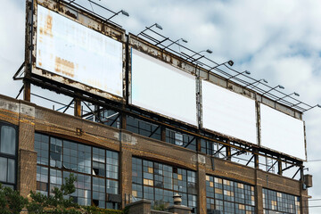 Industrial chic area with high vertical blank billboards, near modern lofts and studios.