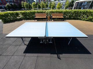 Concrete ping-pong table. Outdoor sports ground. Modern urban public space.