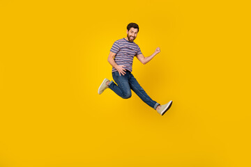 Full length body photo of young adult bearded man jumping and loves playing guitar in air isolated...